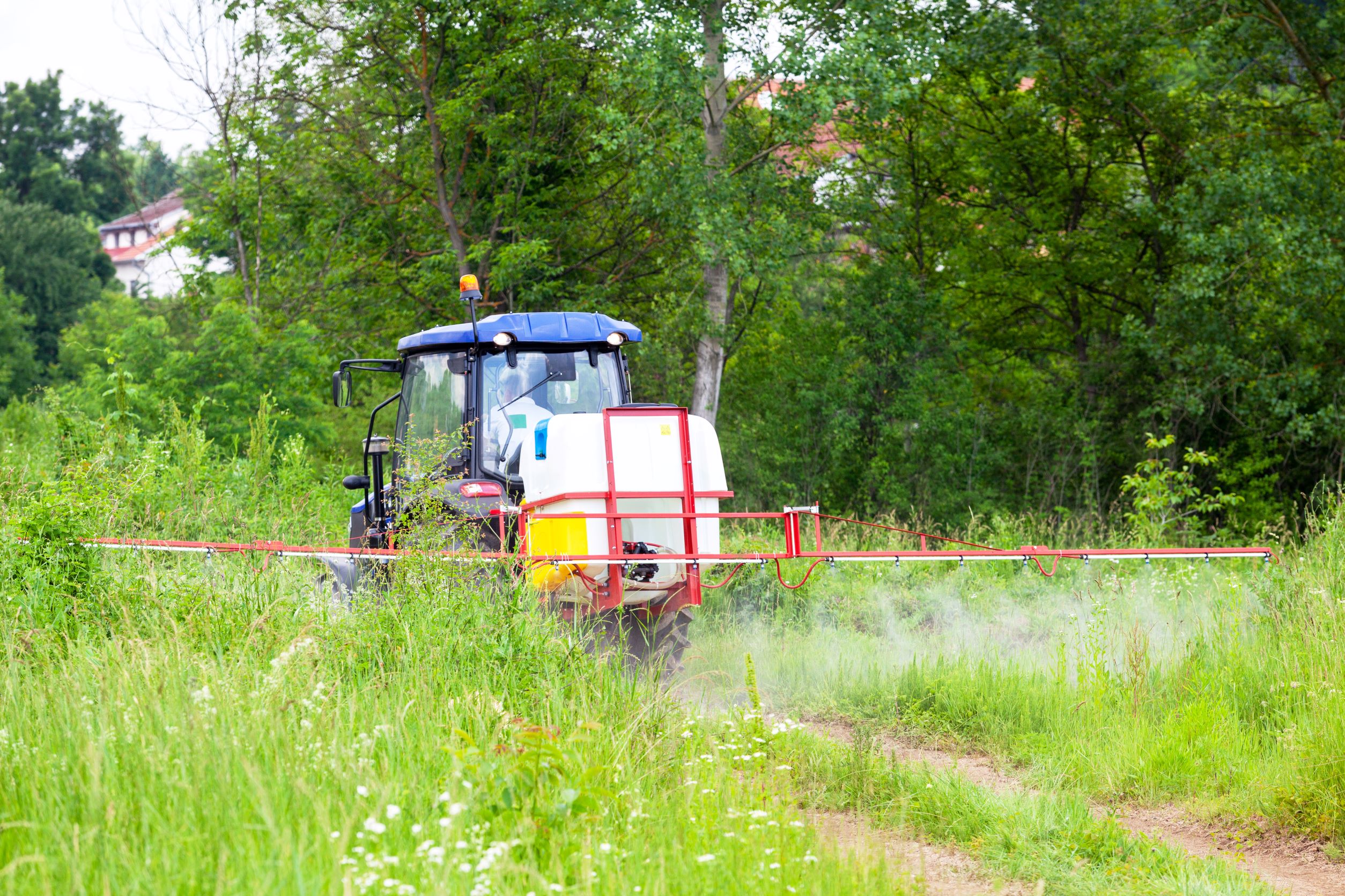Tractor covering a wide area with mosquito repellent.